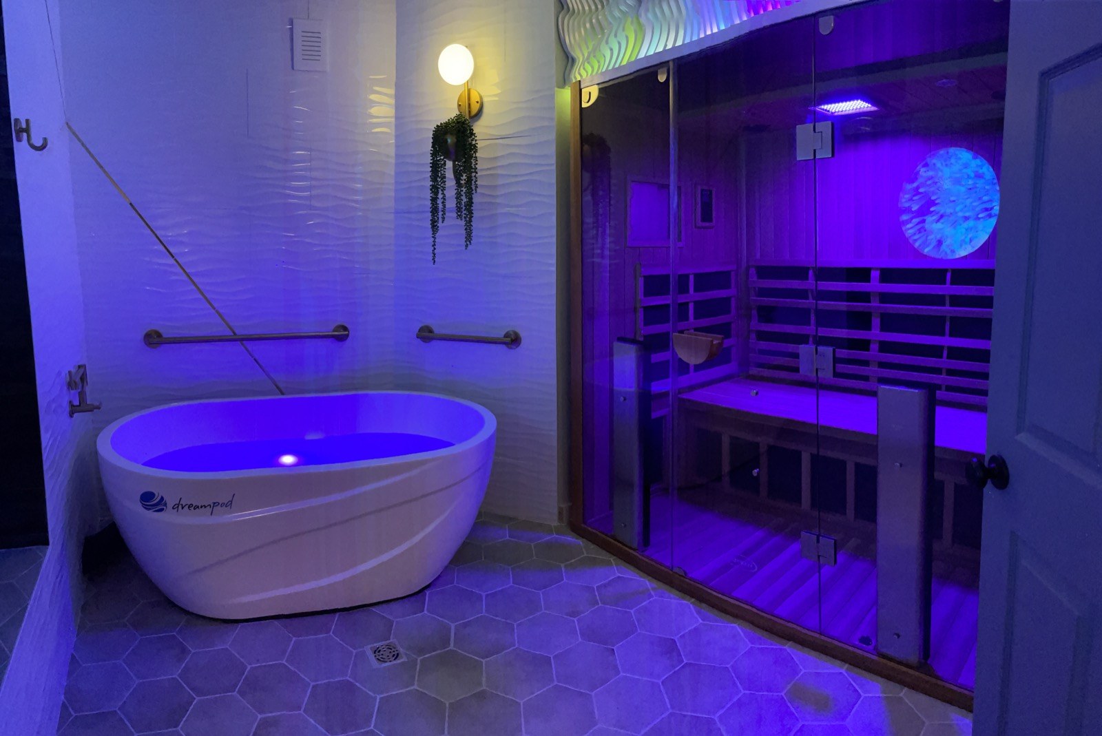 The contrast therapy room at Areté, cold plunge tub beside the cedar sauna